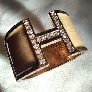 Used Gold toned crystal H bangle
